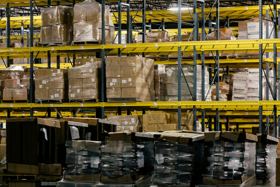 Warehouse shelves with boxed inventory for Shopify purchase order reporting